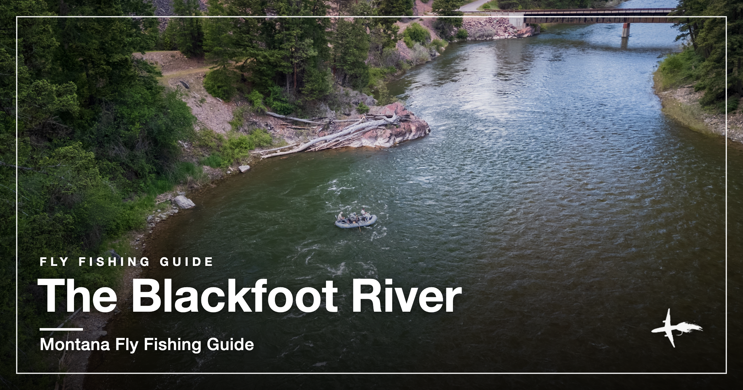 Aerial drone view of a drift boat fly fishing the Blackfoot River through a forested canyon near Missoula, Montana