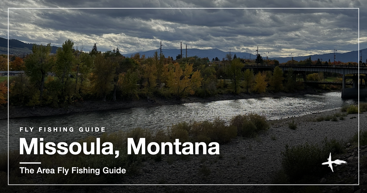 A river running through Missoula, Montana with a bridge and autumn cottonwoods