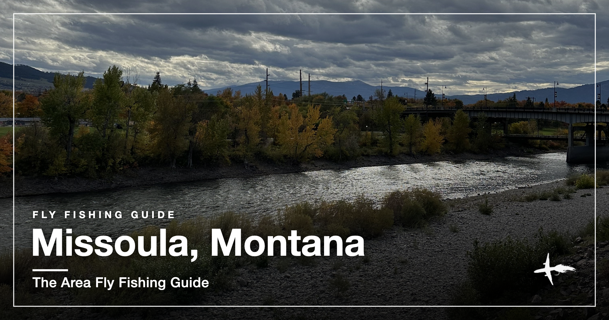 A river running through Missoula, Montana with a bridge and autumn cottonwoods